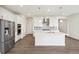 Bright kitchen boasts stainless appliances, gray backsplash, and a large center island at 1884 Sawtooth Mountain Dr, Berthoud, CO 80513