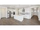 Open kitchen with stainless steel appliances, white cabinets, large island, and sleek design at 1884 Sawtooth Mountain Dr, Berthoud, CO 80513