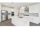 Modern kitchen with white cabinetry, stainless steel appliances, and a center island at 1884 Sawtooth Mountain Dr, Berthoud, CO 80513