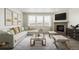 A spacious living room with a fireplace, large windows, comfortable seating, and stylish decor at 1884 Sawtooth Mountain Dr, Berthoud, CO 80513