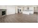 Spacious open-concept space featuring hardwood flooring, a fireplace, and seamless connection to the kitchen at 1884 Sawtooth Mountain Dr, Berthoud, CO 80513