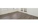An empty room featuring wood flooring, bright white trim, and double doors, offering a versatile space at 1884 Sawtooth Mountain Dr, Berthoud, CO 80513