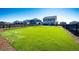 Expansive green backyard featuring artificial turf, wood fencing and mulch, ideal for outdoor enjoyment at 129 S Waterloo St, Aurora, CO 80018