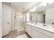 Bright bathroom boasts double sinks, modern fixtures, and a spacious glass-enclosed shower at 129 S Waterloo St, Aurora, CO 80018
