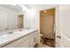 Bathroom featuring a dual-sink vanity and a separate toilet and shower area at 129 S Waterloo St, Aurora, CO 80018