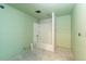 Unfinished bathroom with green walls and a new shower and tub combo at 129 S Waterloo St, Aurora, CO 80018