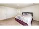 Cozy bedroom featuring neutral carpeting and a comfortable bed with a floral patterned comforter at 129 S Waterloo St, Aurora, CO 80018