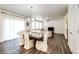 Dining room with modern chandelier, and hardwood flooring flowing to the living room at 129 S Waterloo St, Aurora, CO 80018