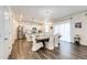 Open-concept kitchen and dining area with stainless steel appliances and a large island at 129 S Waterloo St, Aurora, CO 80018