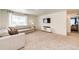 Comfortable living room with carpet, sectional sofa, tv and white entertainment center at 129 S Waterloo St, Aurora, CO 80018