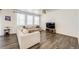 Bright living room with neutral decor, wood-look flooring, and large windows at 129 S Waterloo St, Aurora, CO 80018