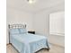 Bedroom with bright-colored bedding, a queen sized bed, and an end table at 470 Kiowa Ave, Bennett, CO 80102
