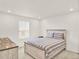 Bedroom with neutral colored bedding, a full sized bed, and a dresser at 470 Kiowa Ave, Bennett, CO 80102
