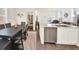 An open-concept dining room and kitchen with stainless steel appliances and modern finishes at 470 Kiowa Ave, Bennett, CO 80102