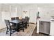 Dining room with hardwood floors, new windows, a modern table set, and recessed lighting at 470 Kiowa Ave, Bennett, CO 80102