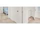 View of the hallway with an open laundry room and bedroom at 470 Kiowa Ave, Bennett, CO 80102
