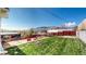 Spacious backyard featuring a well-maintained lawn, patio area with fire pit, and mountain views at 602 5Th St, Golden, CO 80403