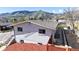 View of the side and rear of the house showing updated siding, landscaping, and mountain views at 602 5Th St, Golden, CO 80403
