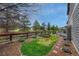 Beautifully landscaped backyard with a wood fence, garden area, and mature trees, perfect for outdoor enjoyment at 3434 Fantasy Pl, Castle Rock, CO 80109