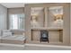 Basement sitting area with a window seat and built-in shelving featuring decorative lamps at 3434 Fantasy Pl, Castle Rock, CO 80109
