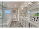 Bright bathroom with double sinks, soaking tub, glass shower, wood-look tile floors, and picturesque window at 3434 Fantasy Pl, Castle Rock, CO 80109