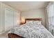 Bright bedroom with floral bedding, side table, closet, and lots of natural light from the large window at 3434 Fantasy Pl, Castle Rock, CO 80109