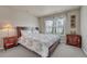 Calming bedroom boasts natural light, floral bedding, side tables, and a dresser for ample storage at 3434 Fantasy Pl, Castle Rock, CO 80109