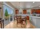 Bright dining area features a chandelier, wood table, and sliding glass doors leading to the deck at 3434 Fantasy Pl, Castle Rock, CO 80109