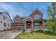 Charming two-story brick home with a covered front porch and a well-manicured lawn at 3434 Fantasy Pl, Castle Rock, CO 80109