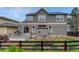 Back exterior view of the home featuring a wood deck, fenced yard, and well-maintained landscaping at 3434 Fantasy Pl, Castle Rock, CO 80109