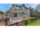 Exterior view of the home with a spacious deck, fenced yard, and lush landscaping, great for enjoying the outdoors at 3434 Fantasy Pl, Castle Rock, CO 80109