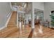 Spacious foyer with hardwood floors, a staircase, and views into the living and dining areas at 3434 Fantasy Pl, Castle Rock, CO 80109