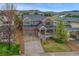 Two-story home with brick and siding, a two-car garage, well-maintained landscaping, and a charming front porch at 3434 Fantasy Pl, Castle Rock, CO 80109