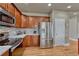 Well-lit kitchen featuring stainless steel appliances, wood cabinets, mosaic backsplash, and granite countertops at 3434 Fantasy Pl, Castle Rock, CO 80109