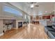 Open-concept living room and kitchen with fireplace, hardwood floors, and large windows at 3434 Fantasy Pl, Castle Rock, CO 80109
