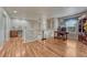 Open living area with wood floors, office space, and staircase with white railings in a well-lit space at 3434 Fantasy Pl, Castle Rock, CO 80109