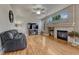 Cozy living room features a fireplace, hardwood floors, and large windows for natural light at 3434 Fantasy Pl, Castle Rock, CO 80109