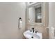 Clean powder room features a white sink, dark fixtures, and a decorative mirror at 3434 Fantasy Pl, Castle Rock, CO 80109