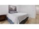 Cozy bedroom featuring neutral-toned walls, light-colored tile flooring, and a comfortable bed at 5765 W Atlantic Pl # 104, Lakewood, CO 80227