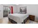 Bright bedroom with sliding glass doors to a balcony and a neutral color palette at 5765 W Atlantic Pl # 104, Lakewood, CO 80227