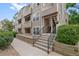 Multi-story condo building featuring covered stairways, neutral siding, and nicely landscaped surroundings at 5765 W Atlantic Pl # 104, Lakewood, CO 80227