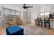 Open concept living space with tile floors, comfortable seating, and a view of the kitchen area at 5765 W Atlantic Pl # 104, Lakewood, CO 80227