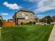 Exterior view of home featuring lush lawn, mature landscaping, and well-maintained yard at 5626 S Biloxi Way, Aurora, CO 80016