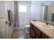 Full bathroom featuring colorful floral shower curtain and a single sink vanity at 5626 S Biloxi Way, Aurora, CO 80016