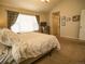 Cozy bedroom features a large window with a view and neutral carpet at 5626 S Biloxi Way, Aurora, CO 80016