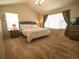 Spacious carpeted bedroom with a queen bed, vaulted ceiling, and large windows at 5626 S Biloxi Way, Aurora, CO 80016