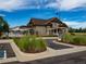 Exterior view of community clubhouse with landscaped grounds, sidewalks, and parking for residents and guests at 5626 S Biloxi Way, Aurora, CO 80016