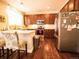 Bright kitchen featuring stainless steel appliances, a breakfast bar, and dark wood cabinets at 5626 S Biloxi Way, Aurora, CO 80016