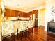 Well-lit kitchen featuring stainless steel appliances, wooden cabinets, and a breakfast bar at 5626 S Biloxi Way, Aurora, CO 80016