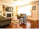 Cozy living room featuring hardwood floors, a fireplace, and comfortable seating at 5626 S Biloxi Way, Aurora, CO 80016